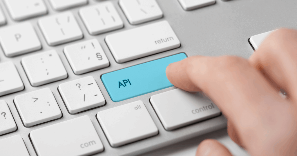 A hand hovers over a keyboard with a key labelled API